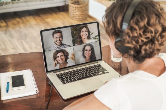 woman having a video conference call with four people at her lap